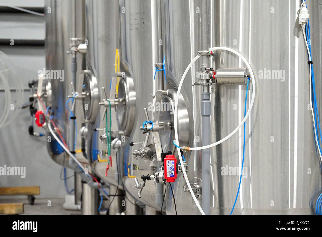 A closeup of Beer vats in a room Stock Photo