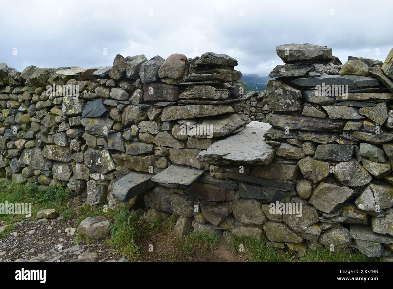 A stile in a dry stone wall at the Castlerigg Stone Circle in the Lake District National Park. Stock Photo