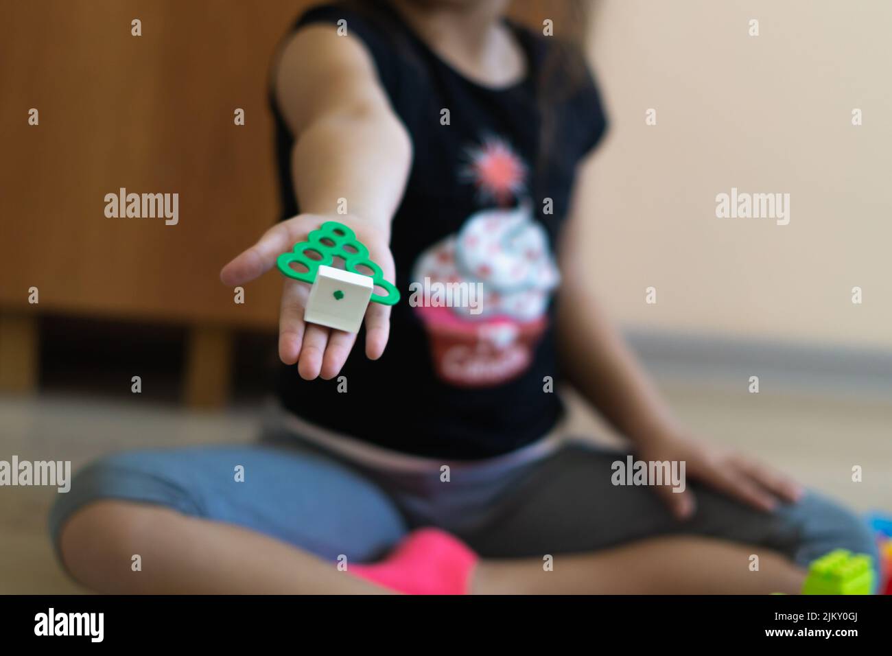little girl playing with toys at home, legos type toys Stock Photo - Alamy