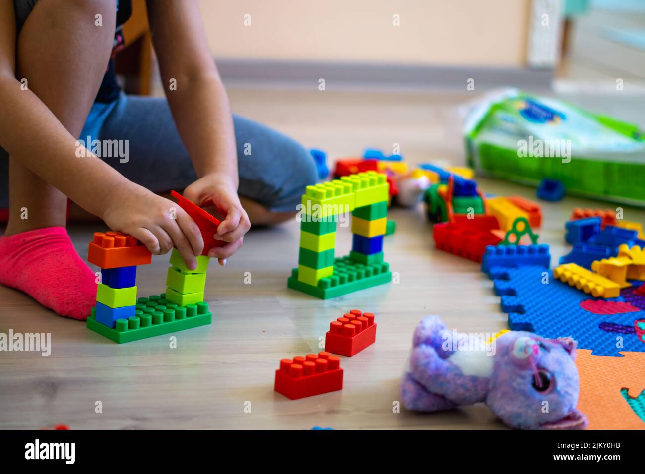 little girl playing with toys at home Stock Photo - Alamy