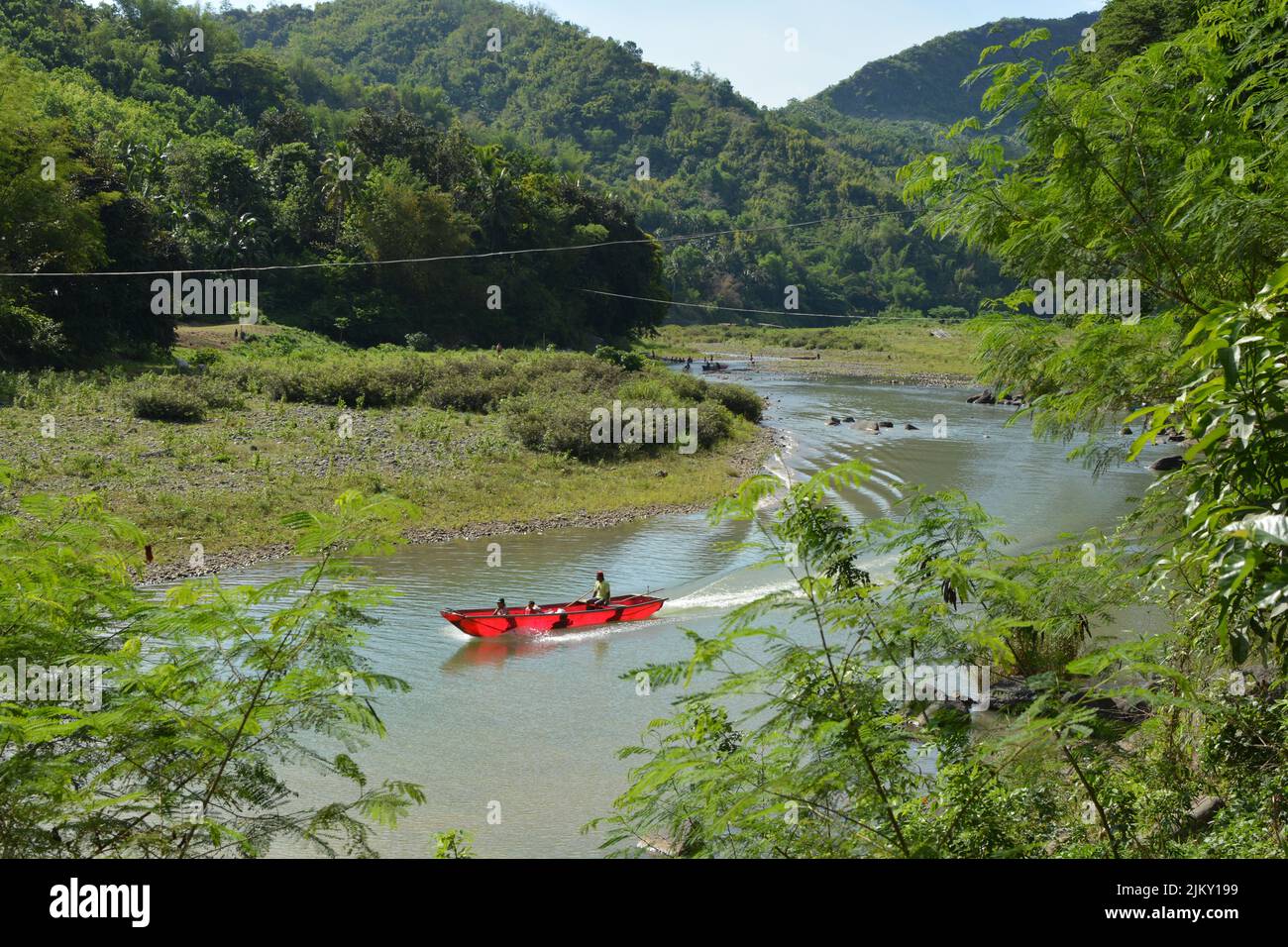A small red motor boat red motor boat in the Wawa River, Rizal, Philippines Stock Photo