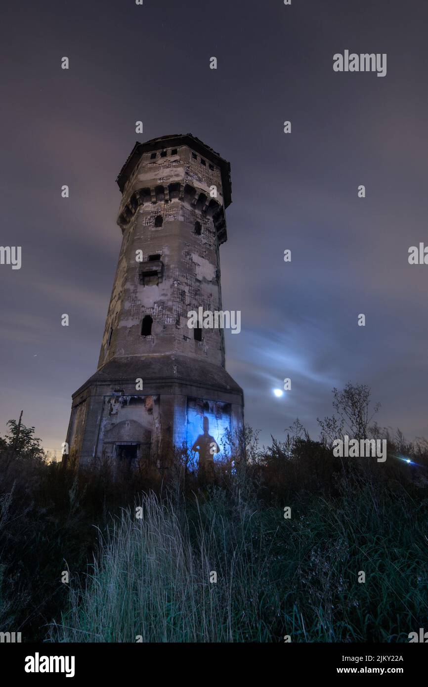 A low angle shot of water tower in field Stock Photo