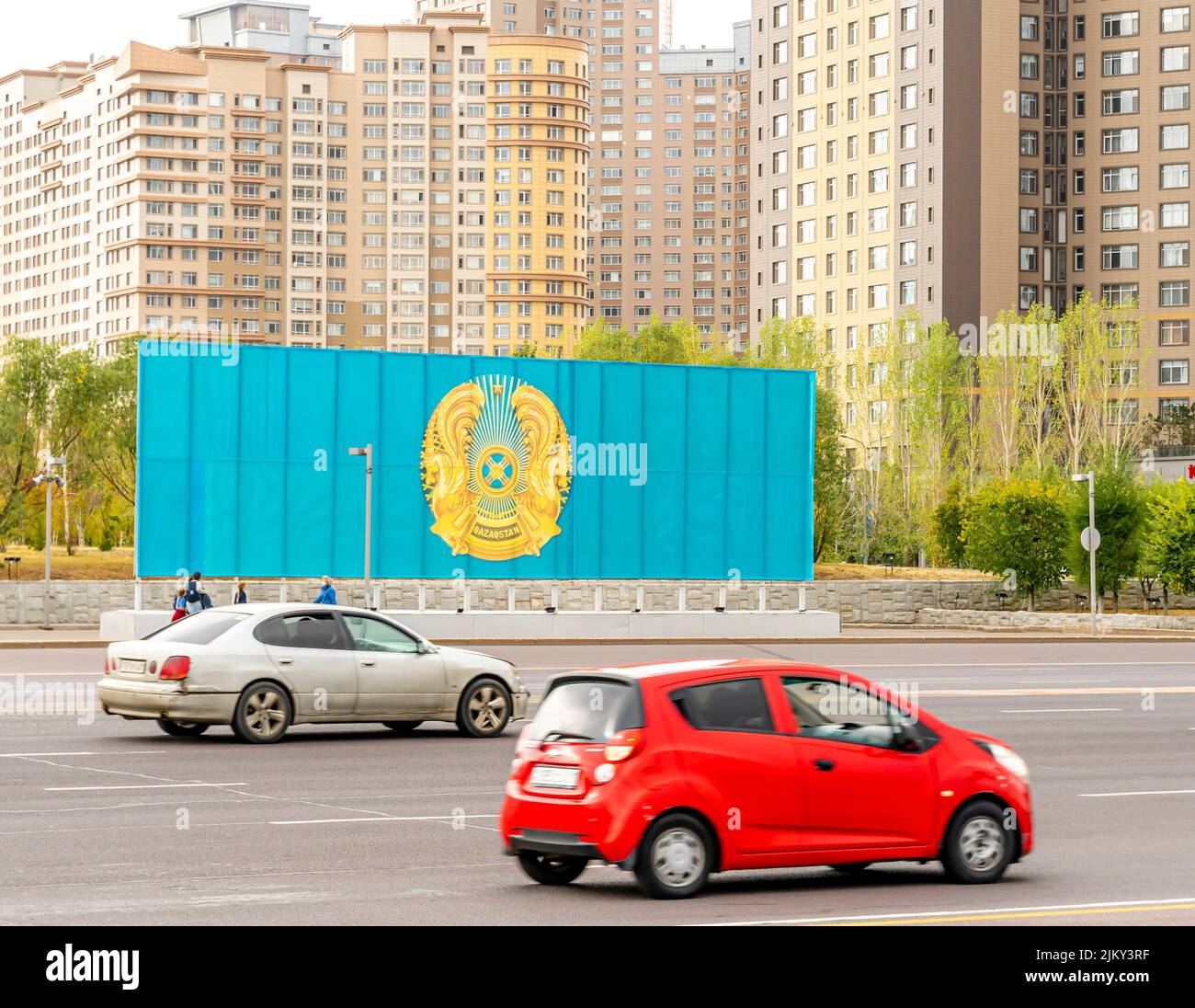 Big Kazakhstan flag on a billboard at Independence Square, Nur-Sultan, Astana, Kazakhstan Stock Photo