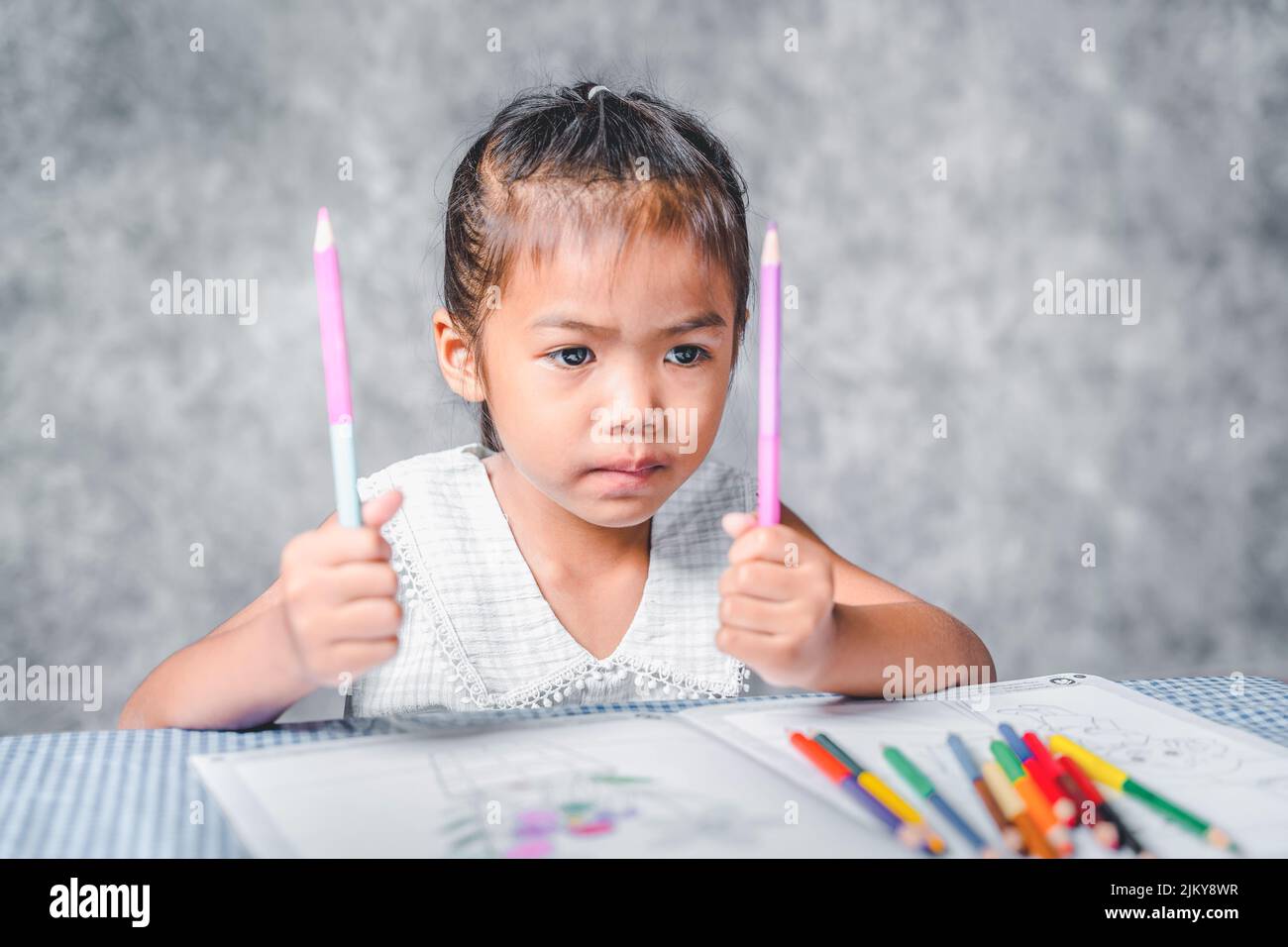 A girl learning to paint on a book She is passionate and fun in