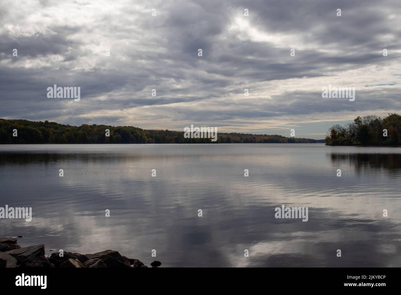 A mesmerizing view of autumn trees with reflection in the lake under ...