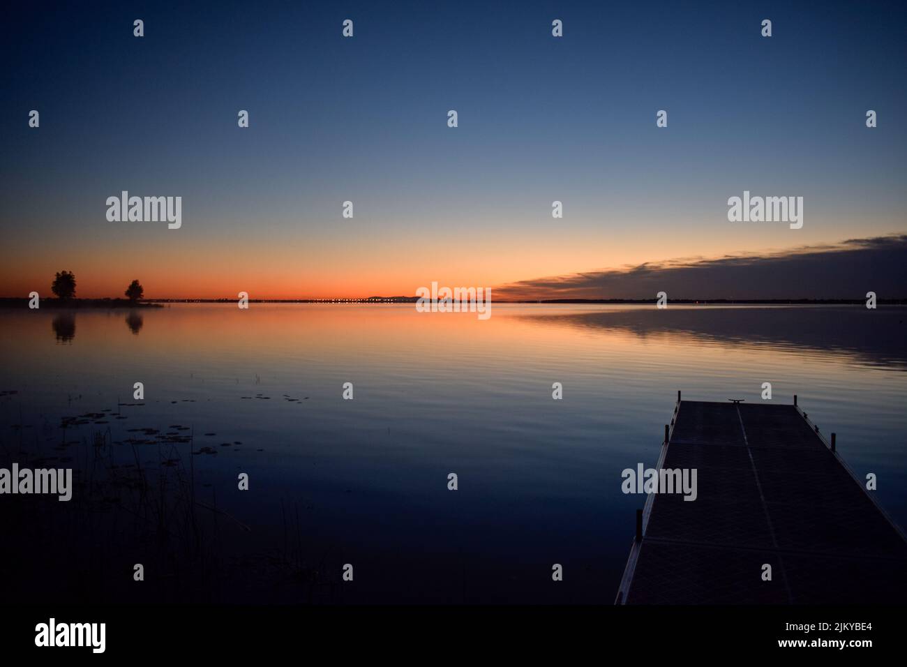 A mesmerizing view of trees with reflection in a lake during susnet in ...