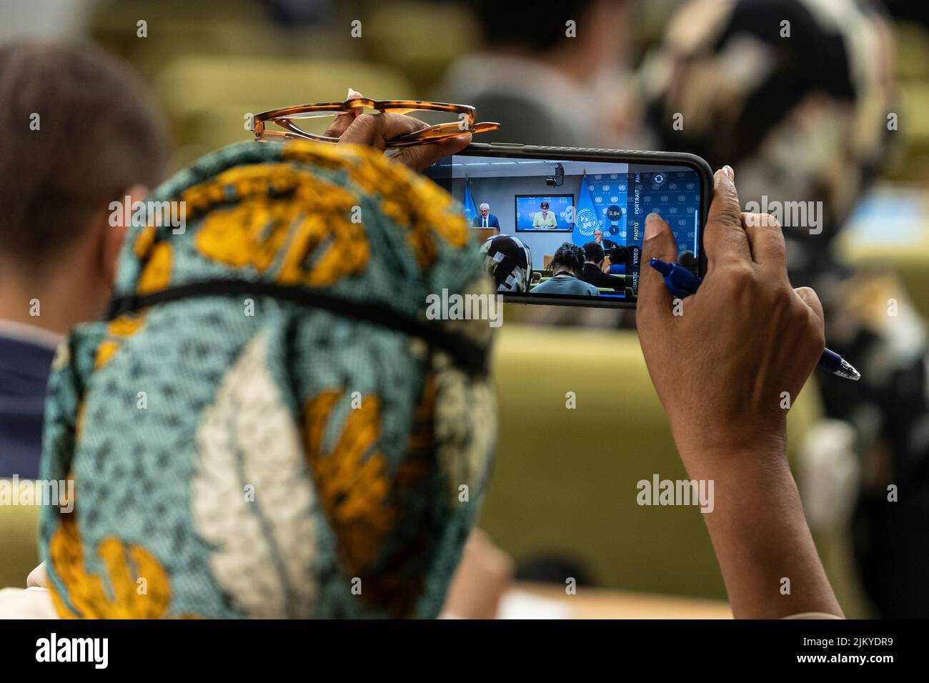 New York, New York, USA. 3rd Aug, 2022. Deputy Secretary-General Amina Mohammed takes photo of Secretary-General Antonio Guterres press briefing on launch of the 3rd brief by the GCRG on Food, Energy and Finance at UN Headquarters. Report by Global Crisis Response Group and Rebeca Grynspan who joined virtually from Geneva highlighted global insecurity on shortage of food, energy and finance after COVID-19 pandemic and exacerbated by war Russia is waging on Ukraine. Secretary-General and Ms. Grynspan urged all countries to conserve energy, invest more into renewable energy sources, t Stock Photo