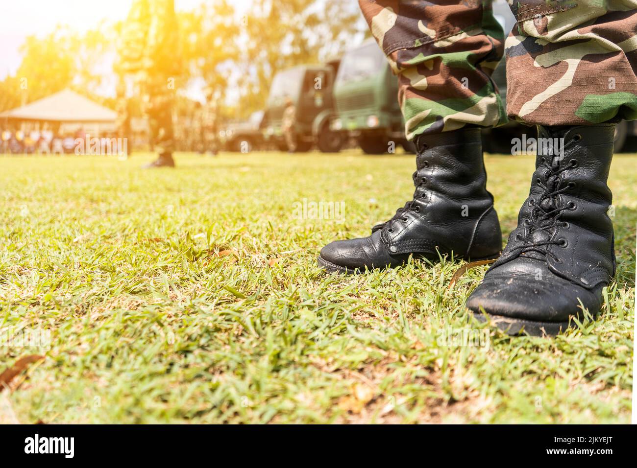 Boots of an unrecognizable Latino soldier in a field in a military ...