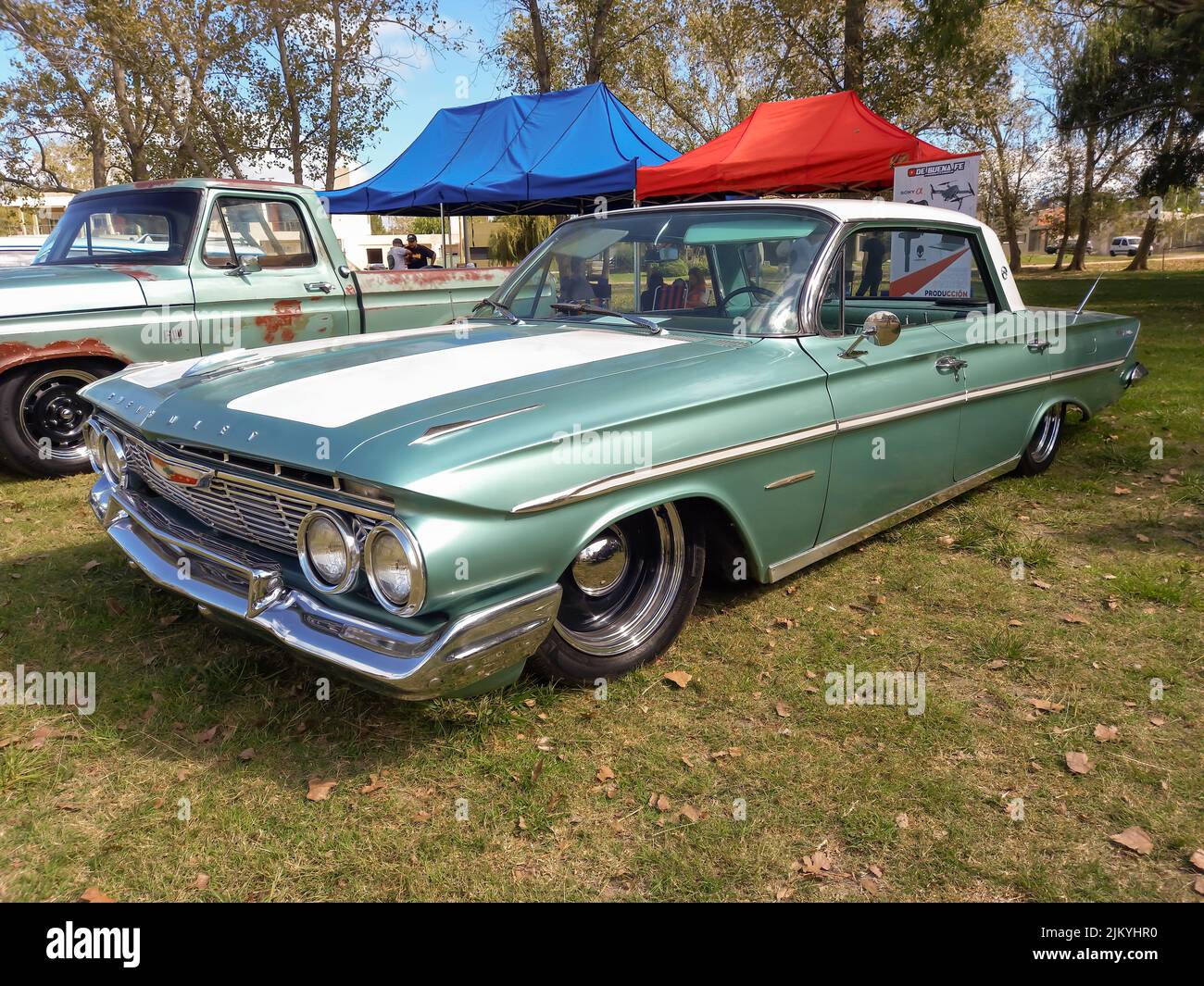 Chascomus, Argentina - Apr 9, 2022 - Old grey Chevrolet Chevy Bel Air sedan four door 1961 classic touring car parked on the grass. Copyspace Stock Photo