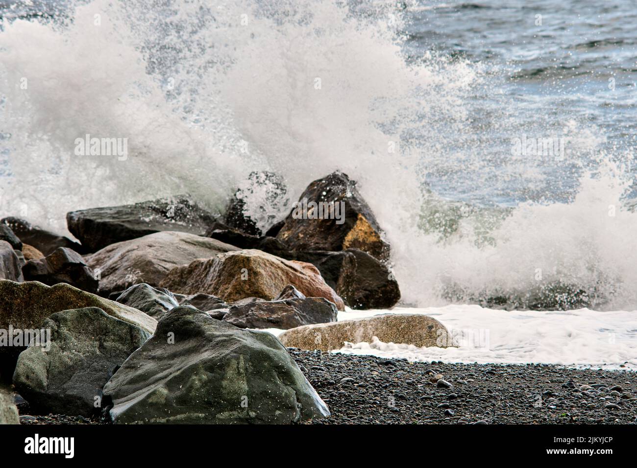 Ocean waves splashing against the rocks on a stormy day, Stock Photo
