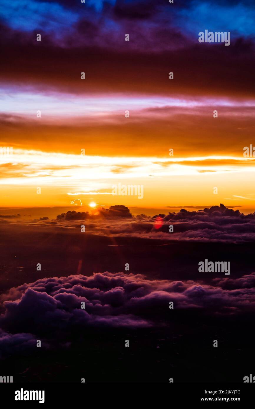 A vertical shot of dramatic sky with clouds during sunset Stock Photo