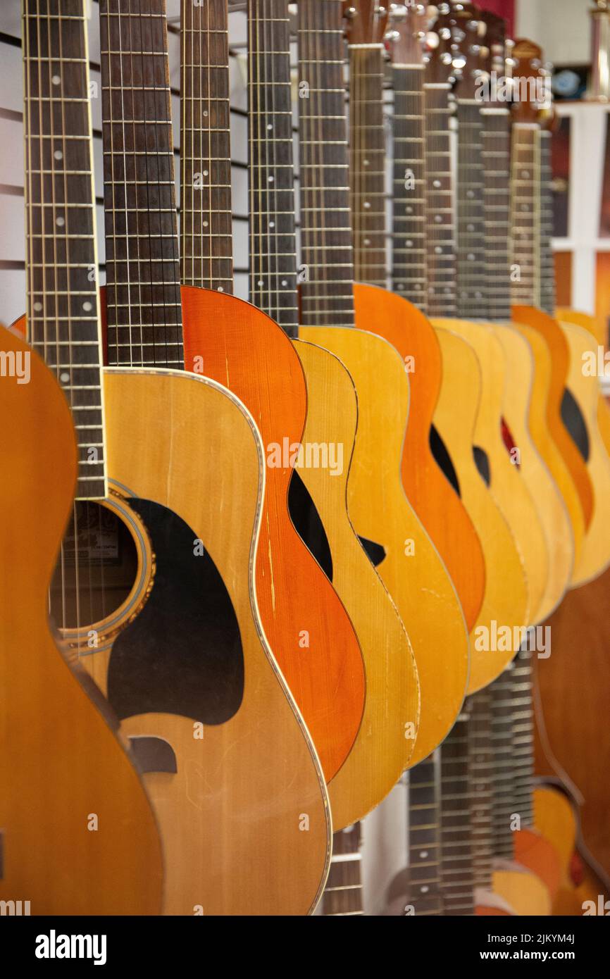 A line of hanging guitars Stock Photo