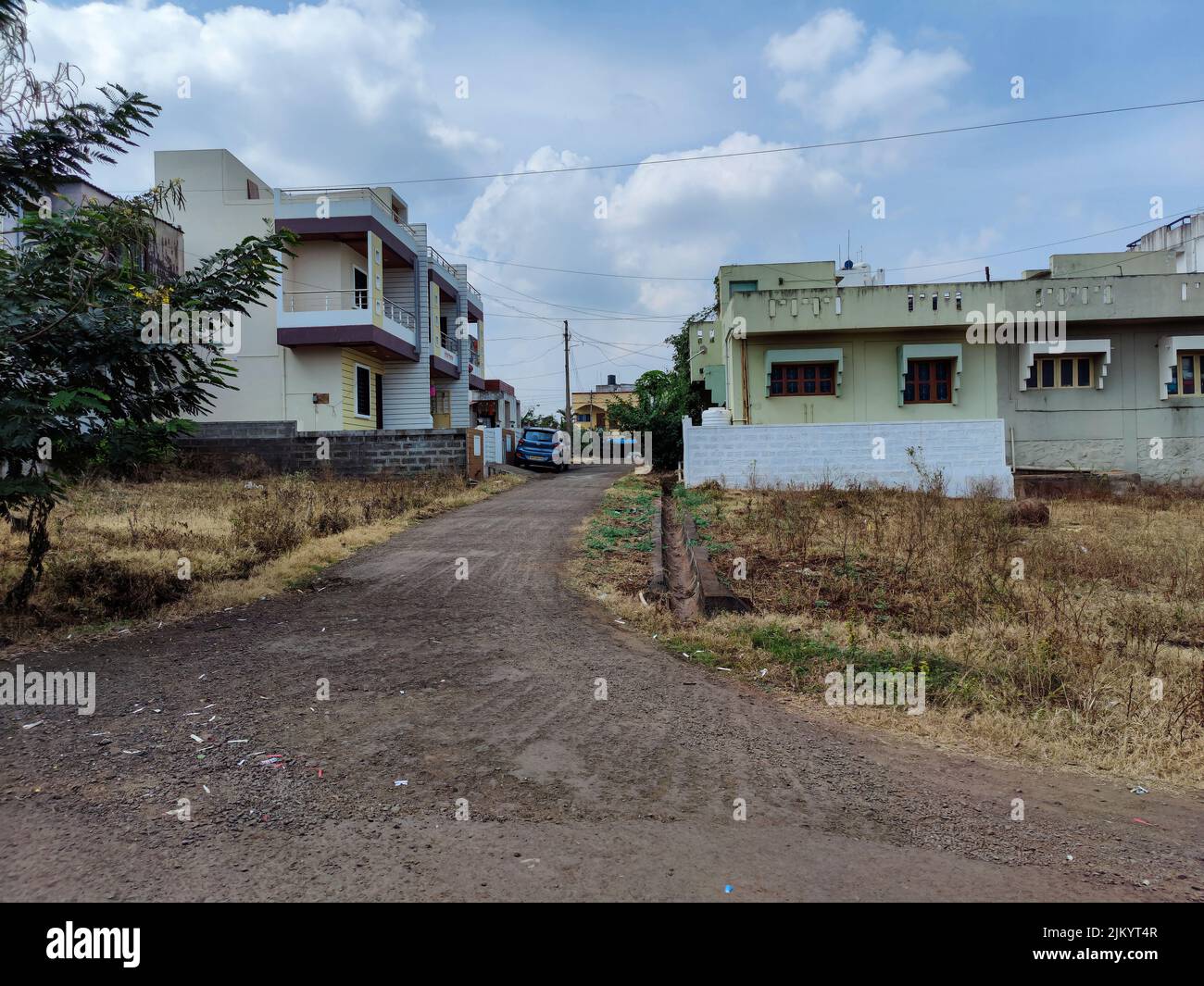Kolhapur,India- November 6th 2021;Scenic view of residential colony in Kolhapur city. cluster of apartment buildings and houses, green trees parked ve Stock Photo