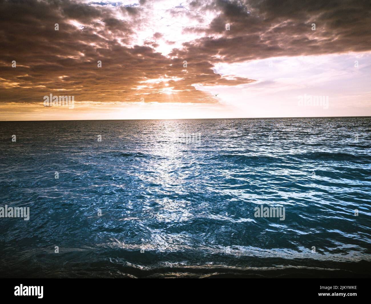 A beautiful scenery of a sea during a sunset Stock Photo - Alamy