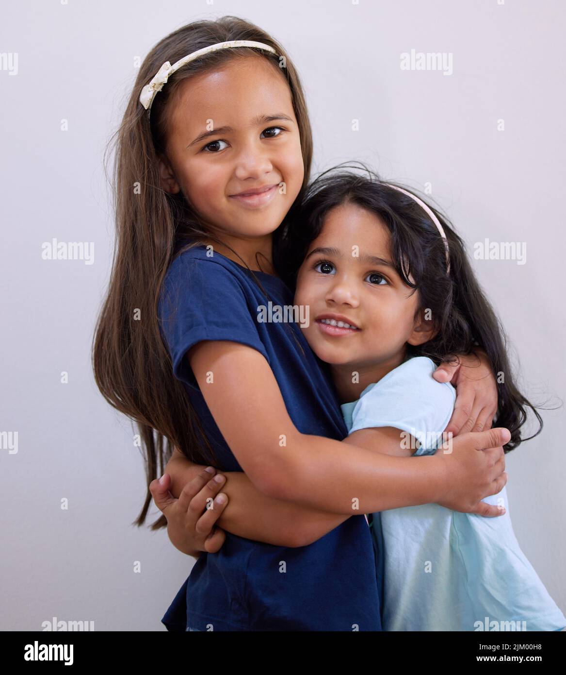 They share an unbreakable bond. two young girls embracing each other ...
