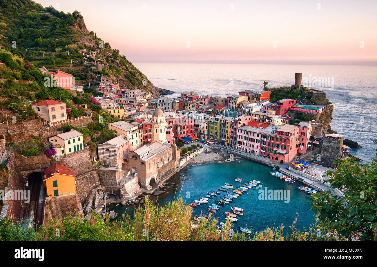 An aerial view of an Italian coastal town of Vernazza with boats in the ocean Stock Photo
