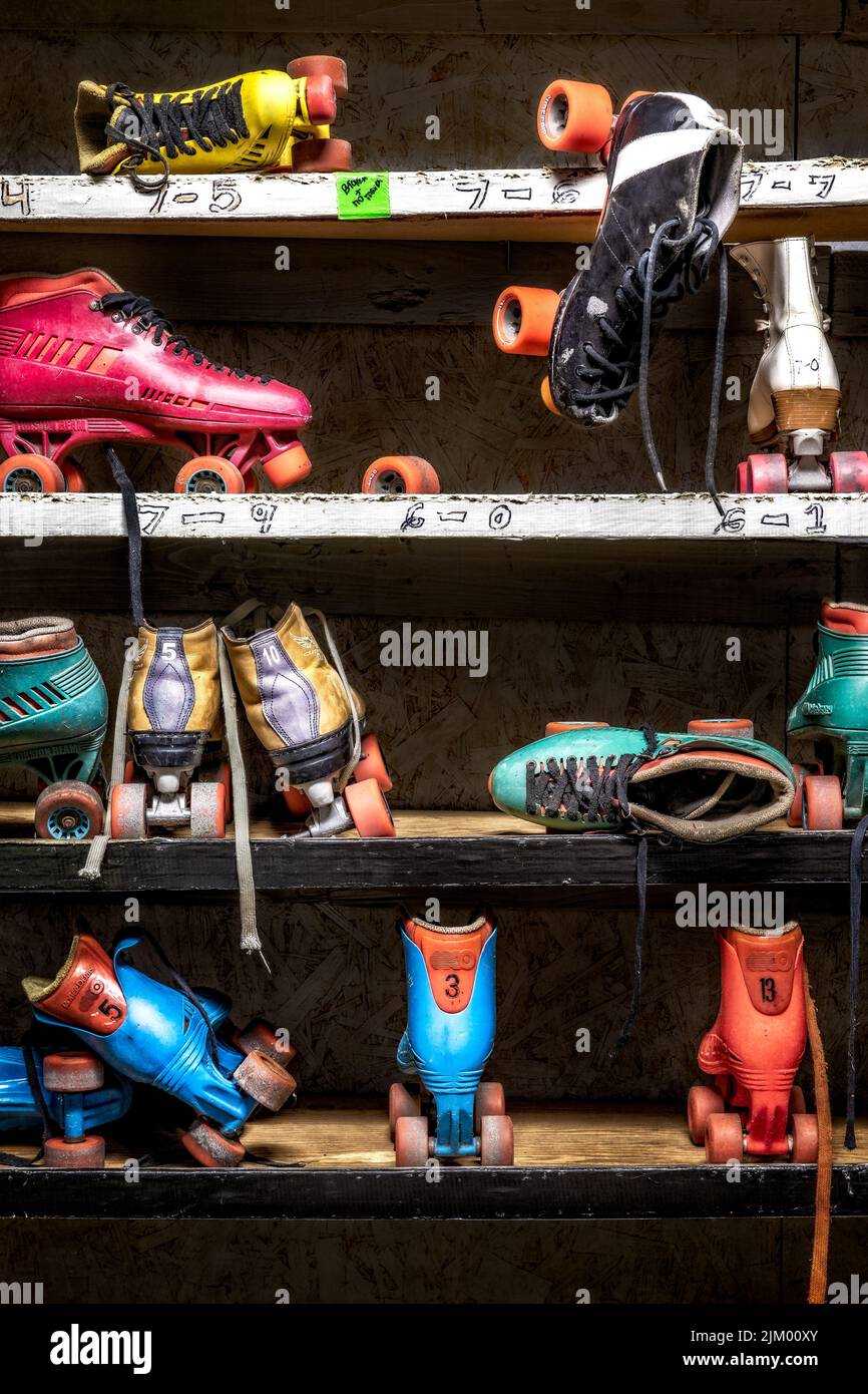 A vertical shot of roller skates strewn in an abandoned roller skating