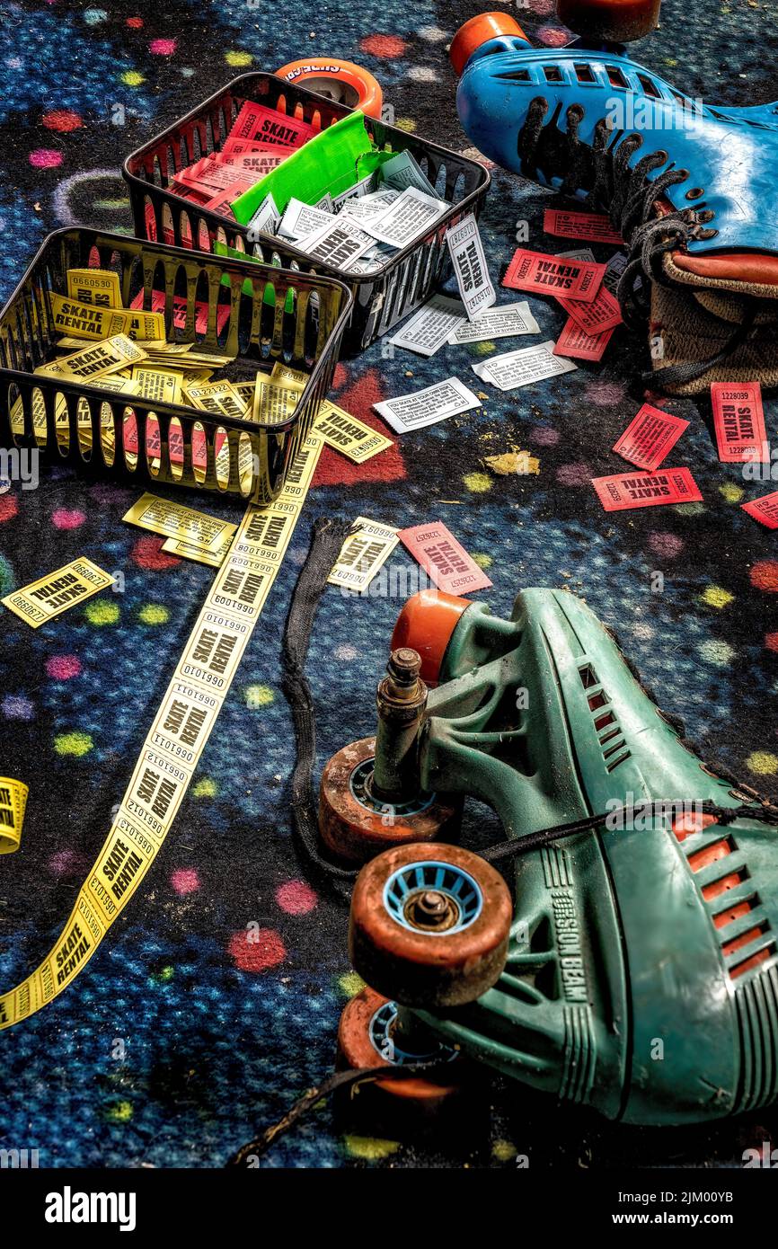 A vertical shot of roller skates and tickets strewn in an abandoned