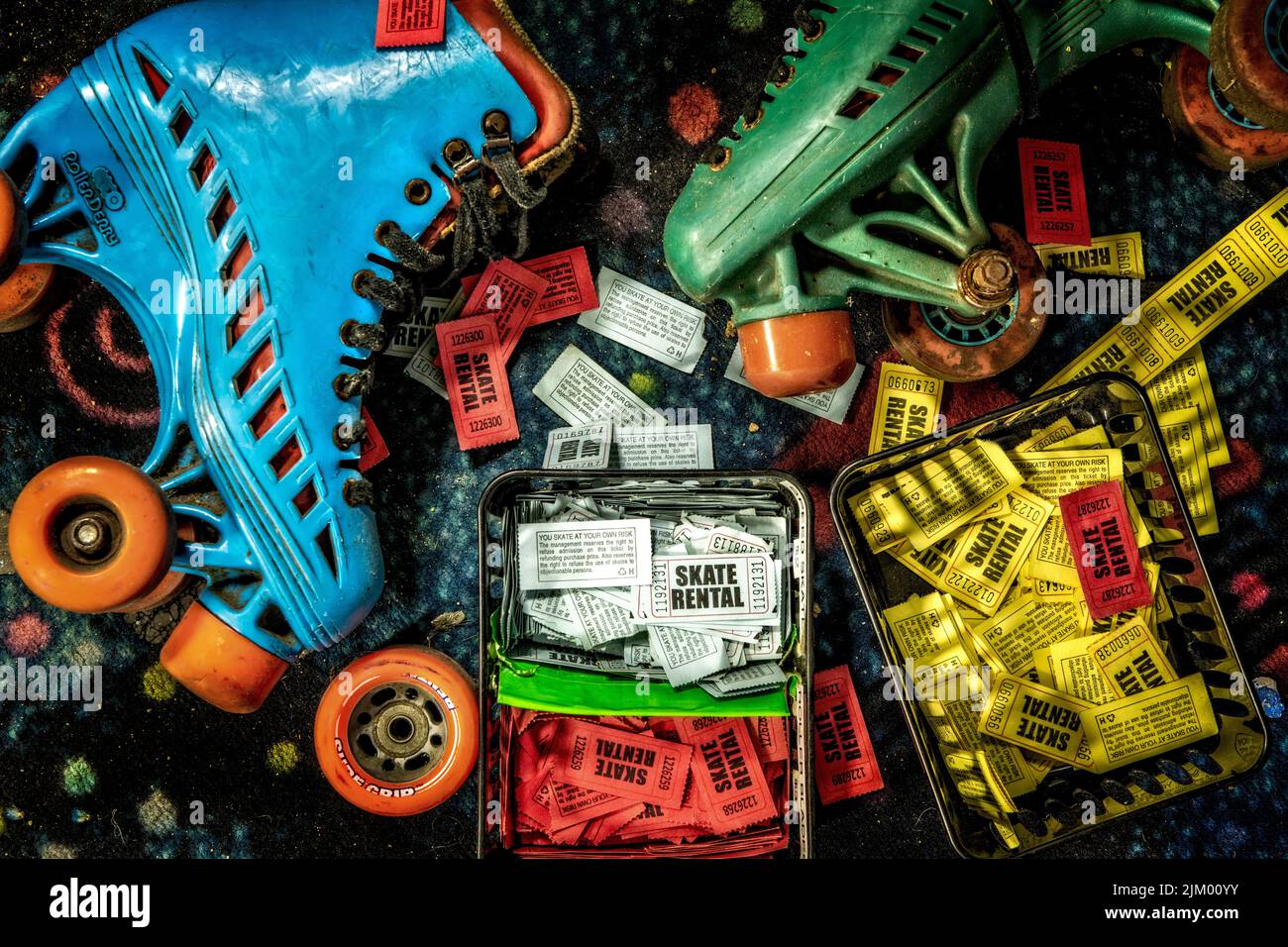 A top view of roller skates and tickets strewn in an abandoned roller