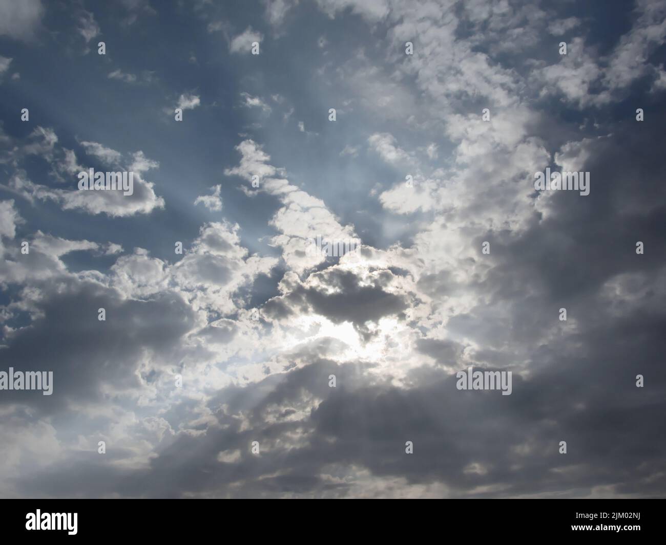Sky with giants cumulonimbus clouds and sun rays through . Stock Photo