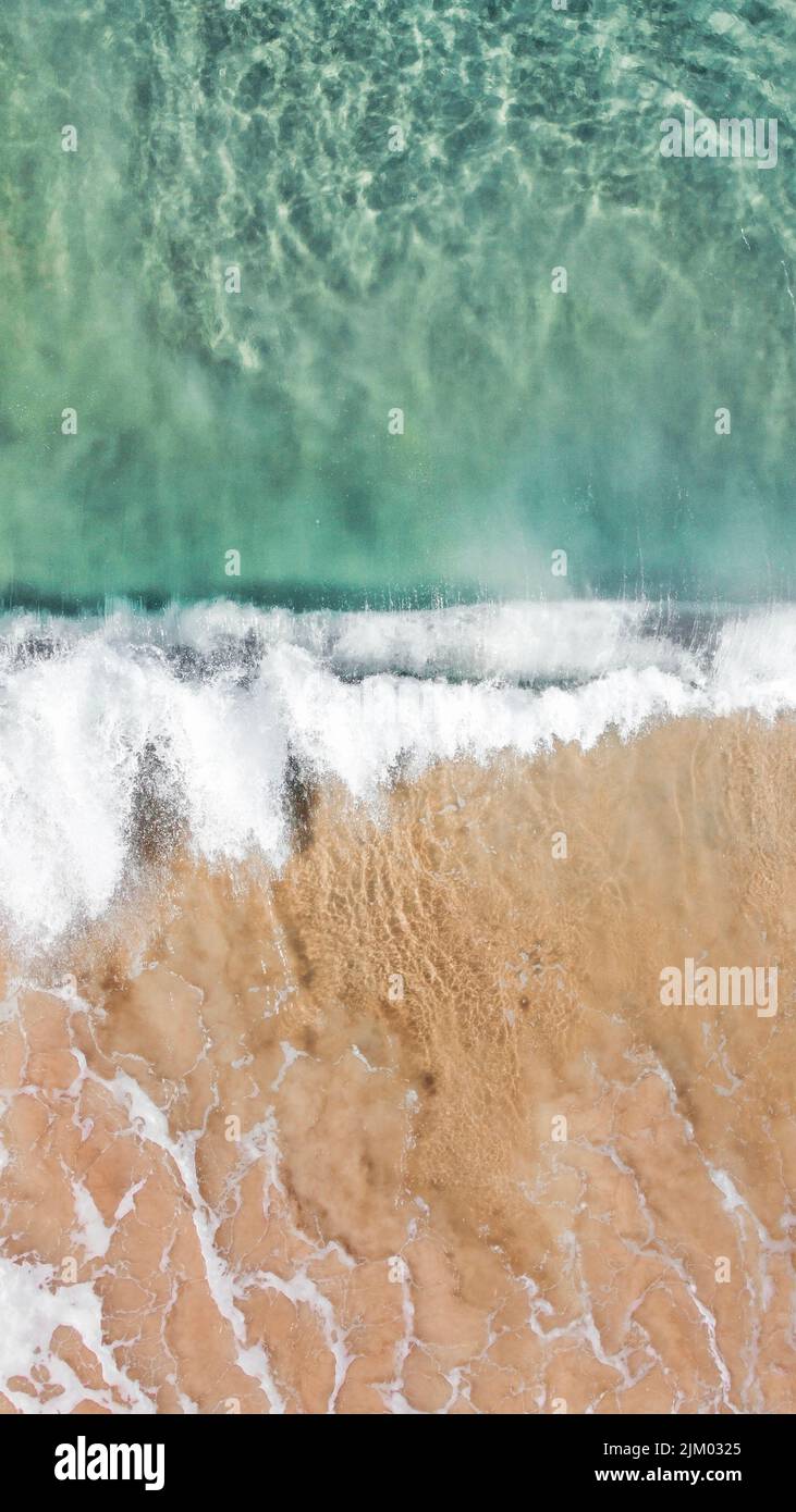 Wave Washing Aerial vertical ocean washing beach hi-res stock photography and images ...