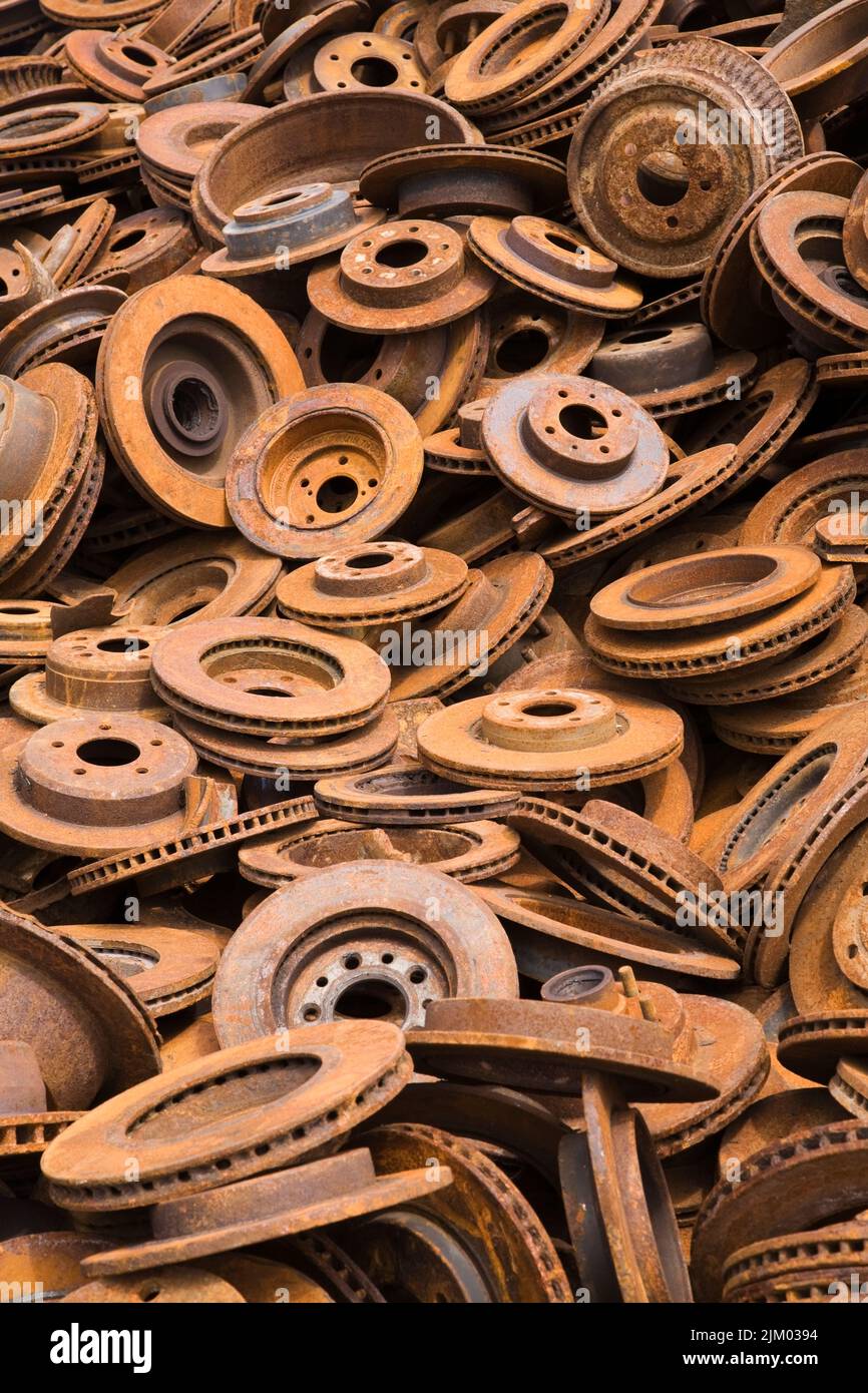 Assorted rusted ferous metal disc and drum brakes at scrap metal