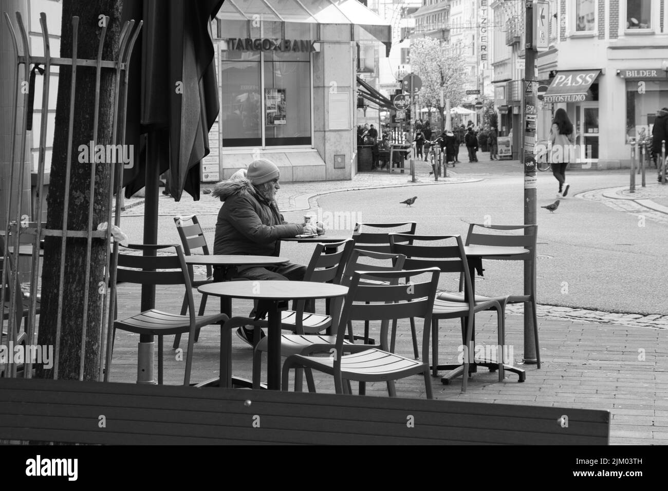 old man having coffee in the city of bonn, black and white photo Stock Photo