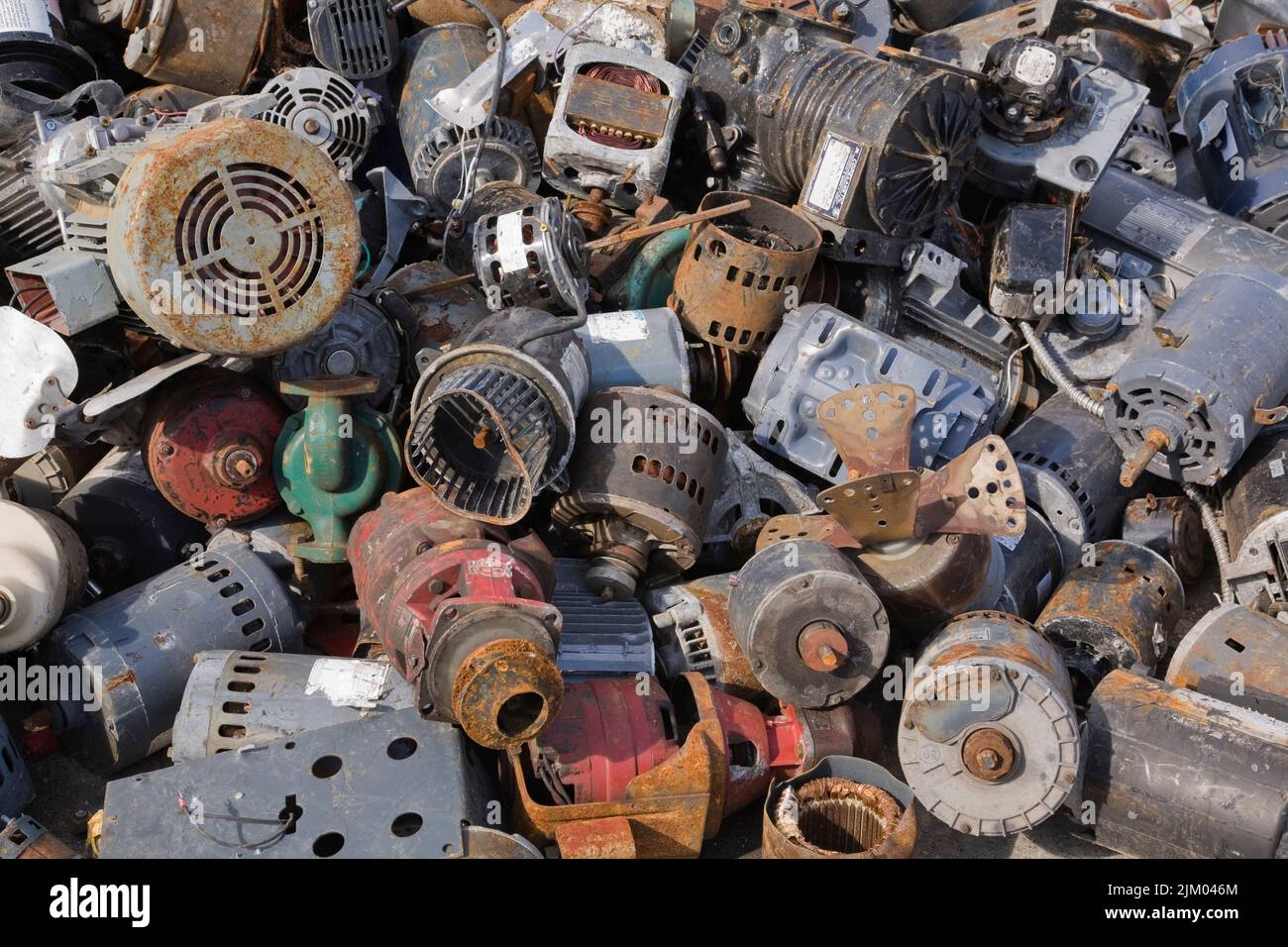 Close-up of discarded electric motors at scrap metal recycling yard. Stock Photo