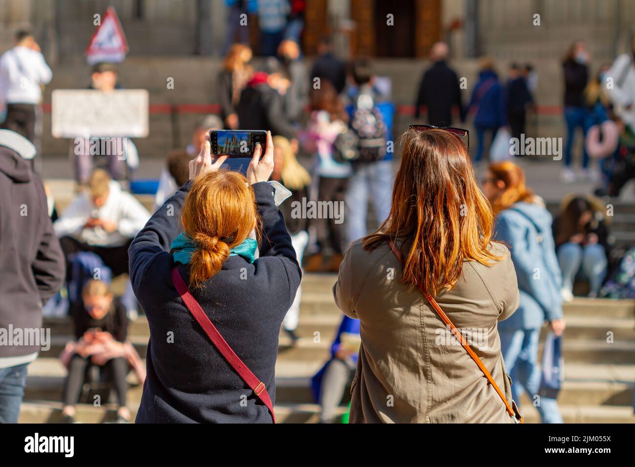 Barcelona, Spain - April 4, 2022: people taking cell phone pictures of the cathedral of Barcelona (Spain). Stock Photo