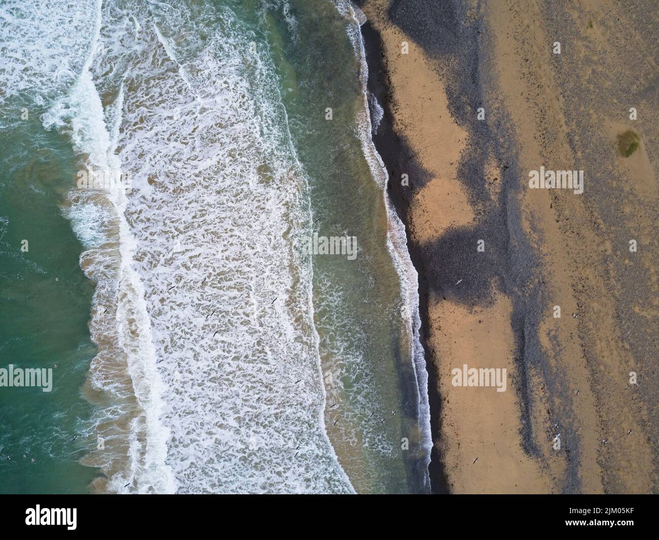 An aerial breathtaking view of waves crashing against the shore Stock ...
