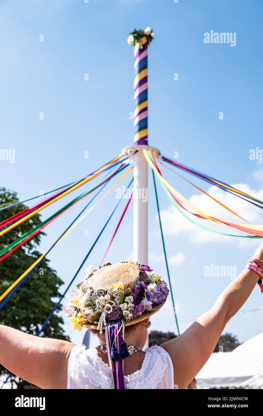 A vertical shot of female in a traditional English hat dancing with a maypole at the Countryfile Live Stock Photo