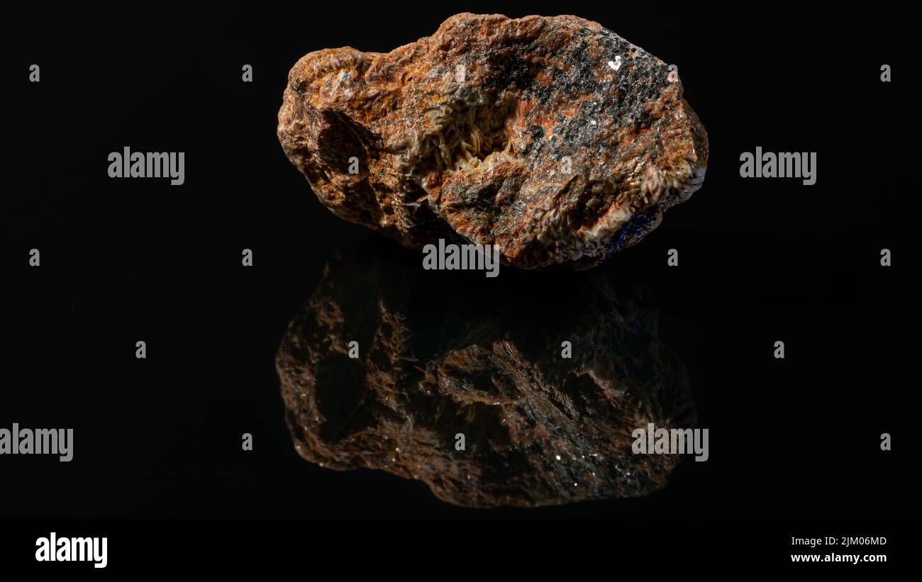 An aged mineral stone with iron ore on a black background Stock Photo ...