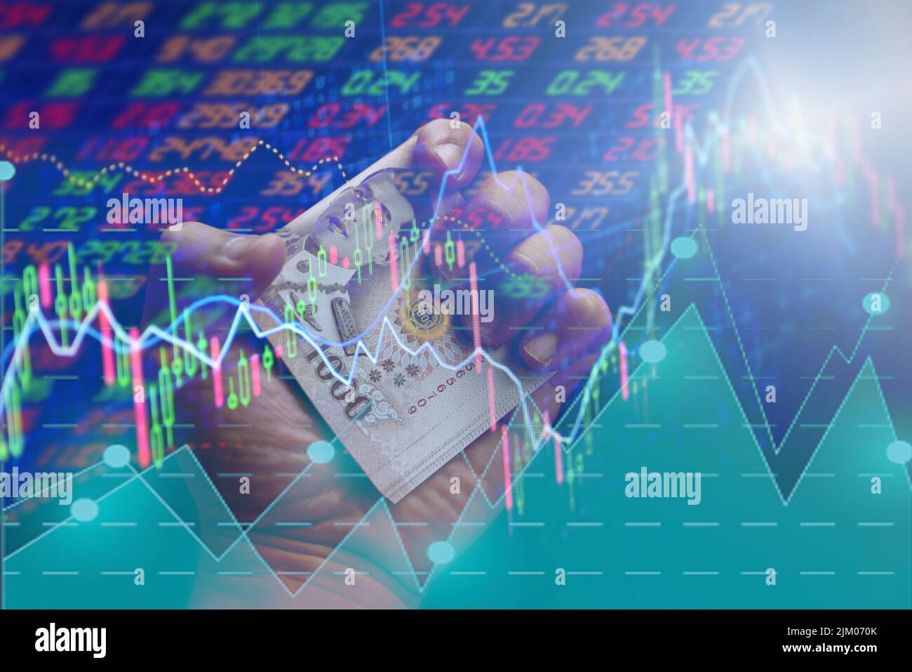 Money Thai 1000 Baht Banknotes In Hand And Stock Chart Trading money-thai-1000-baht-banknotes-in-hand-and-stock-chart-trading
