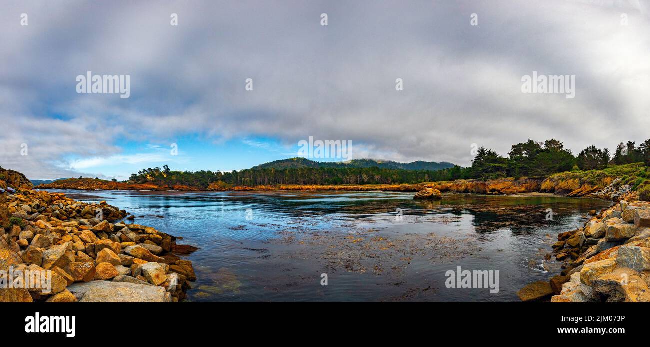 A  calm view of reflective water of Whalers Cove Point Lobos State Reserve Stock Photo