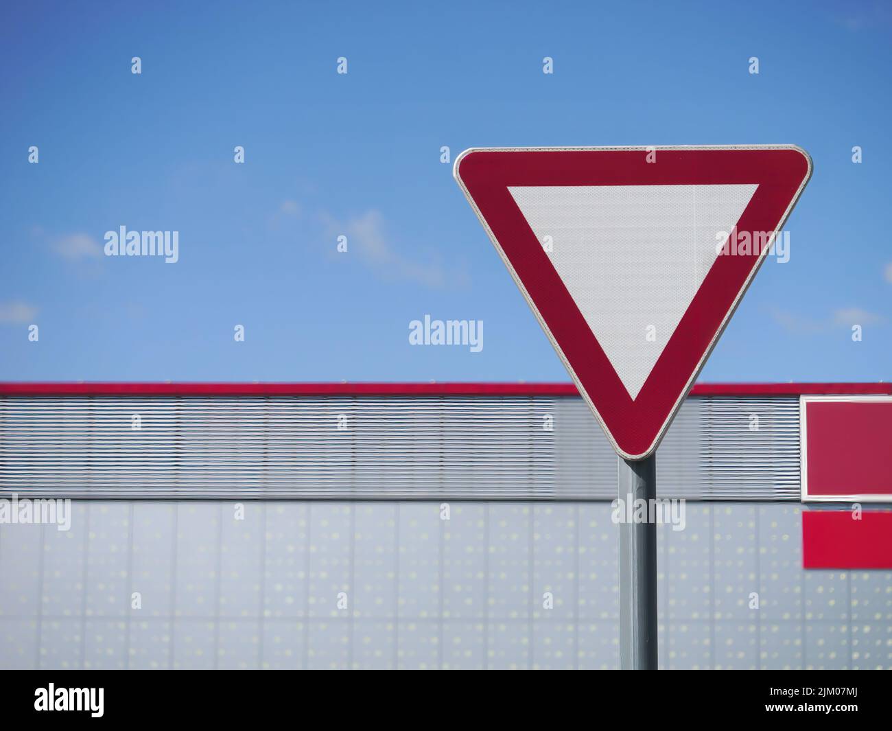 A closeup shot of a red white yield sign on a pole Stock Photo