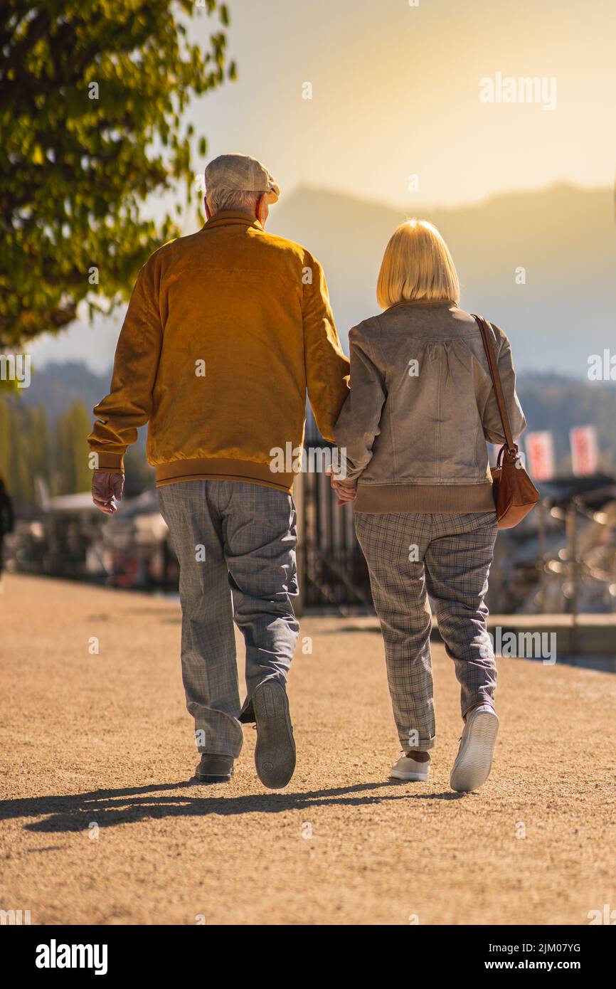 A vertical closeup of an old couple in love on the promenade in Lucerne. Switzerland. Stock Photo