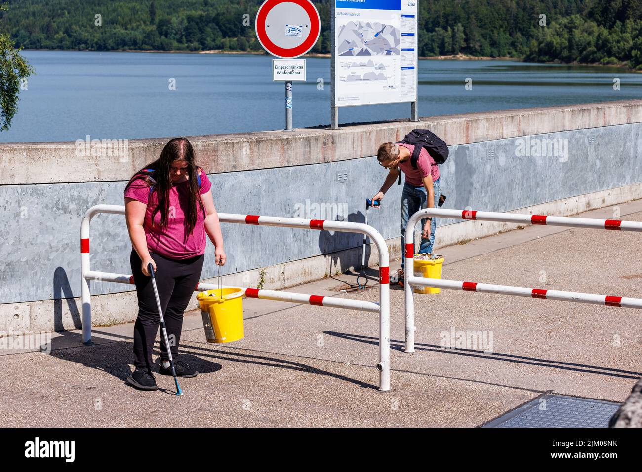 Forbach, Germany. 06th July, 2022. Rene Engels and his girlfriend Michaela collect trash on the Schwarzenbach Dam. Some do sports in their free time, others collect stamps, Rene Engels collects trash. His unusual hobby has a serious background. (to dpa 'Fight against garbage - Rene Engels cleans up Black Forest in his spare time') Credit: Philipp von Ditfurth/dpa/Alamy Live News Stock Photo
