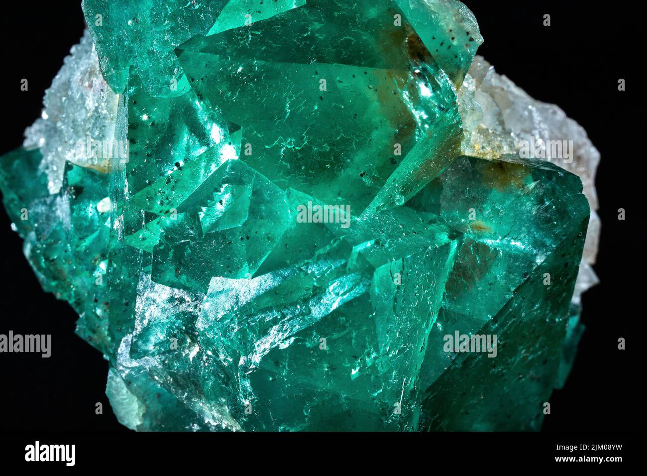 A closeup of a rare mineral row uncut green crystal Stock Photo