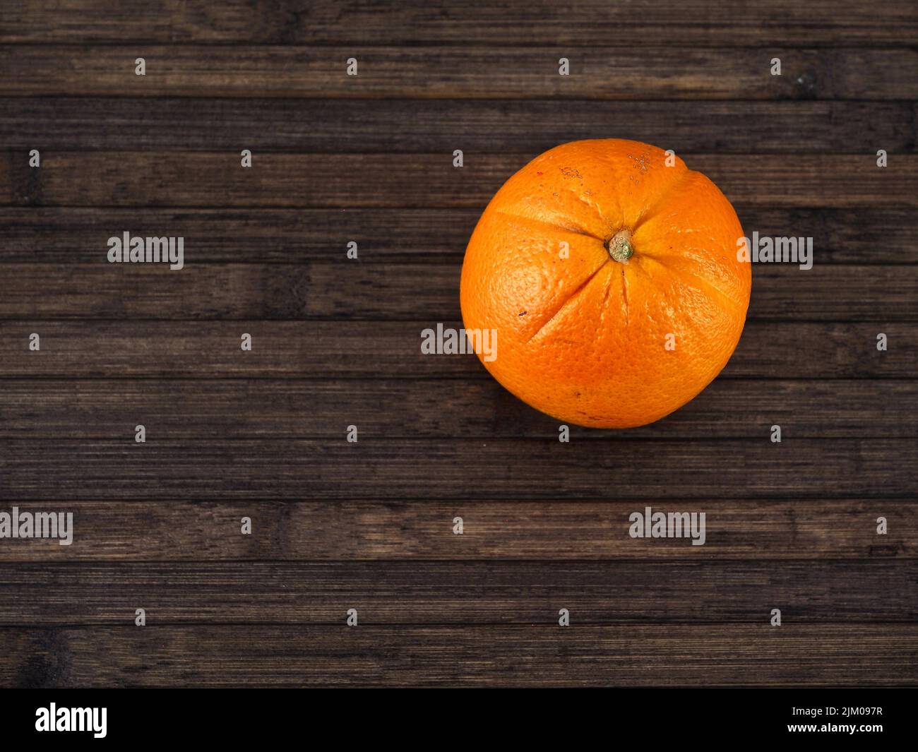isolated orange on a wooden table, view from above Stock Photo