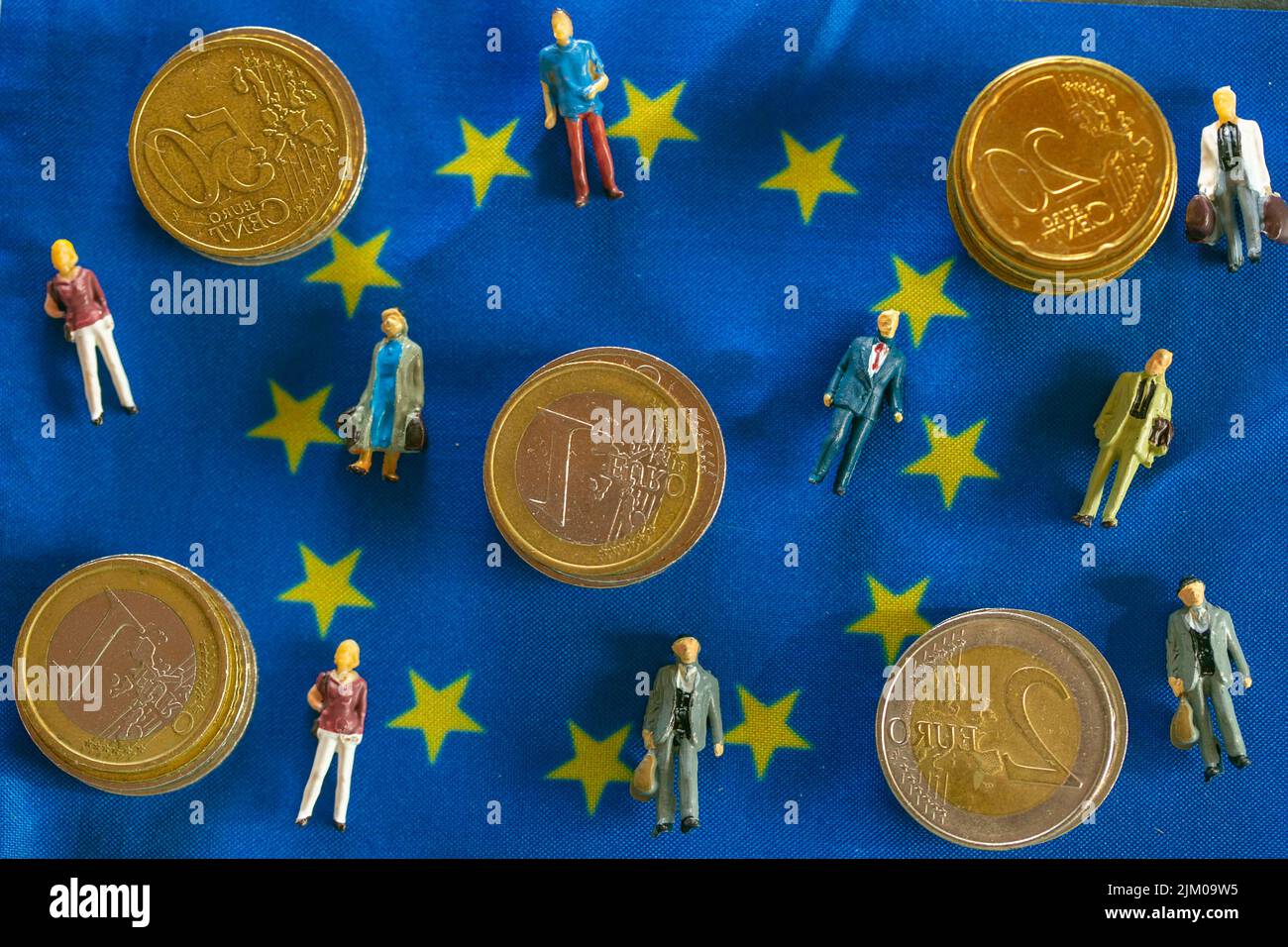 Taxpayers of EU countries.figurines of people and euro coins on european union flag.Tax and price increases in the European Union Stock Photo