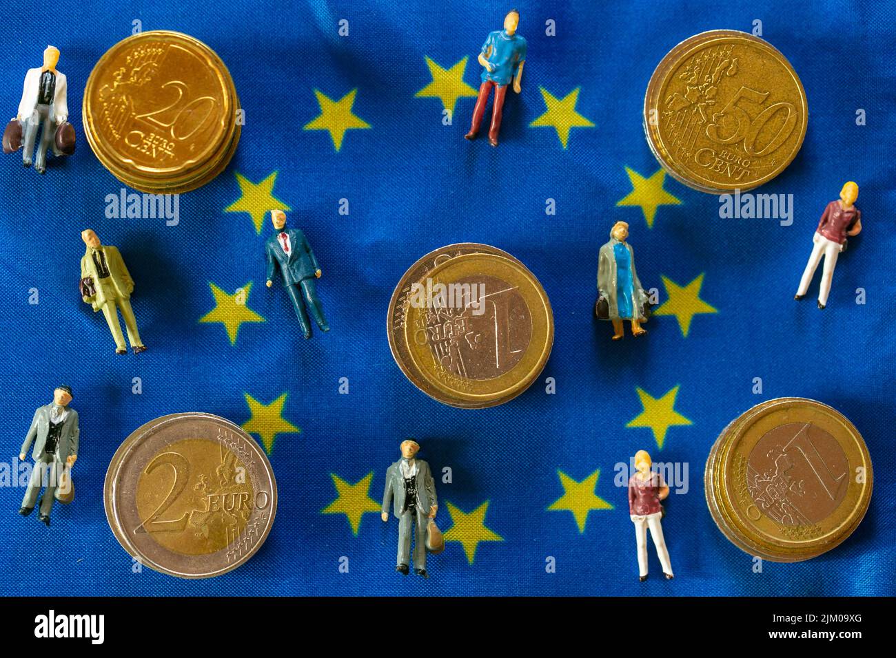 Taxpayers of EU countries.figurines of people and euro coins on european union flag background.Tax and price increases in the European Union Stock Photo