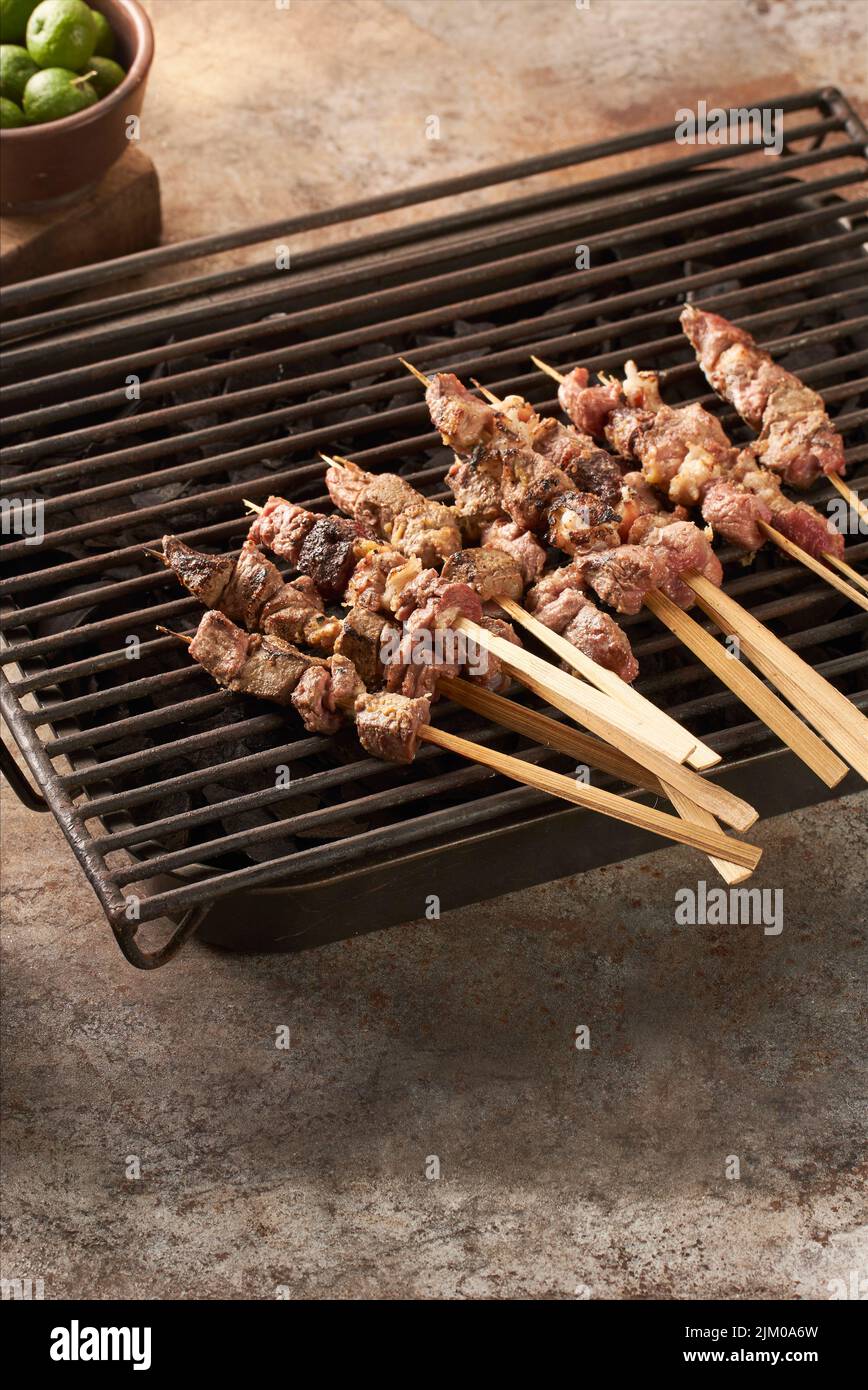 A vertical closeup shot of goat satays ready to be roasted Stock Photo