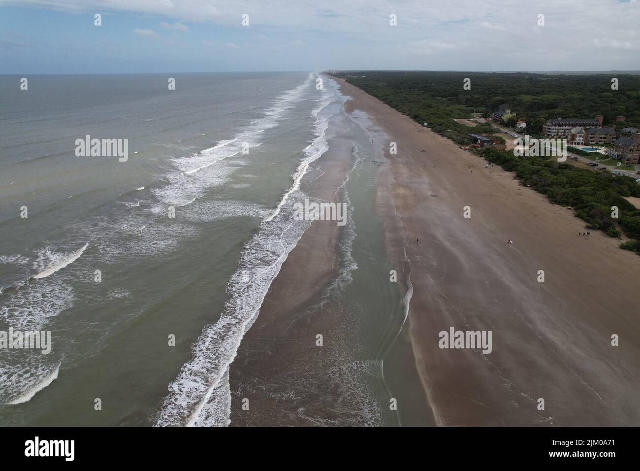 An aerial view of the soft ocean waves with foam on a sandy beach Stock ...