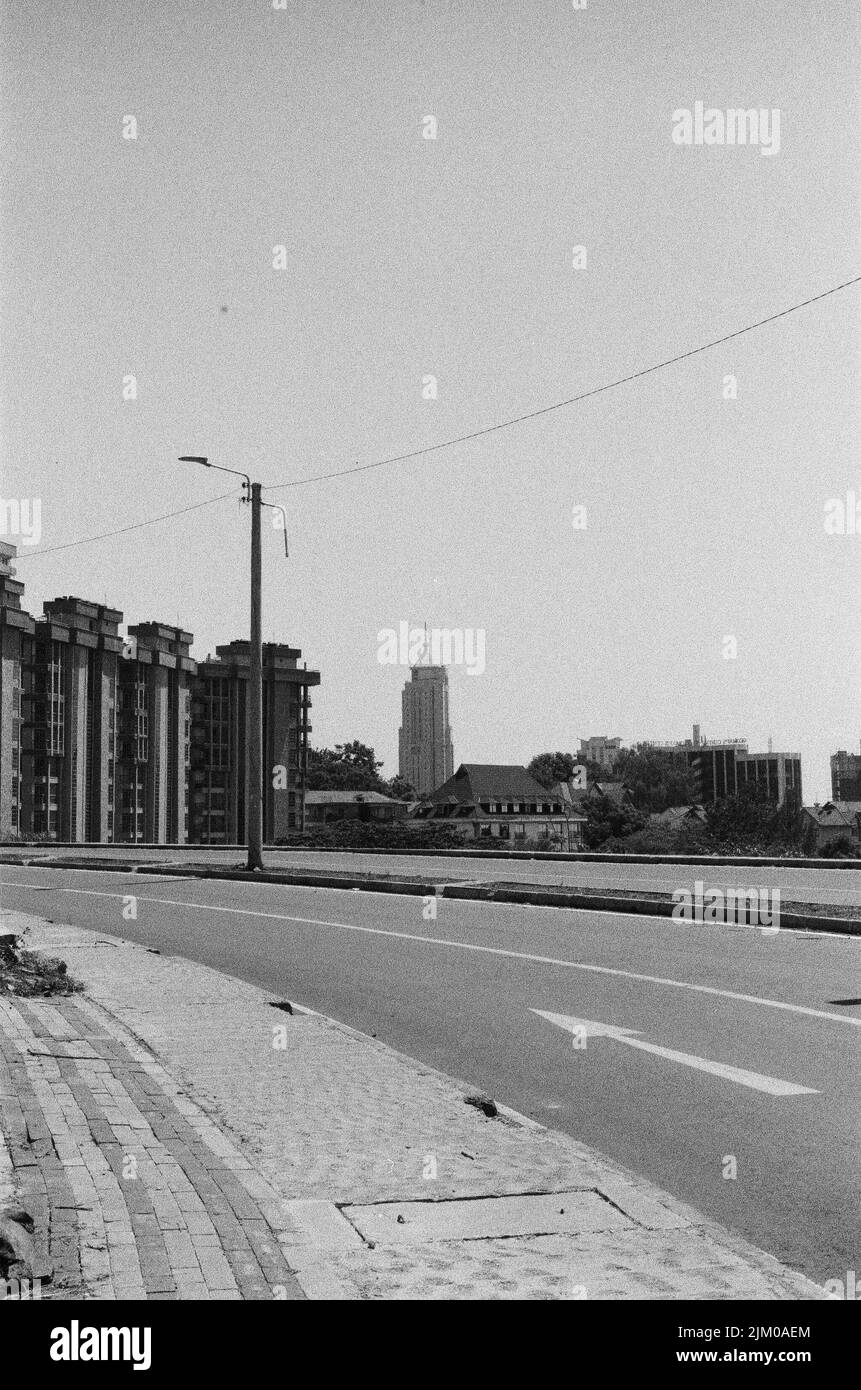 A vertical grayscale shot of an empty street in the city Stock Photo ...