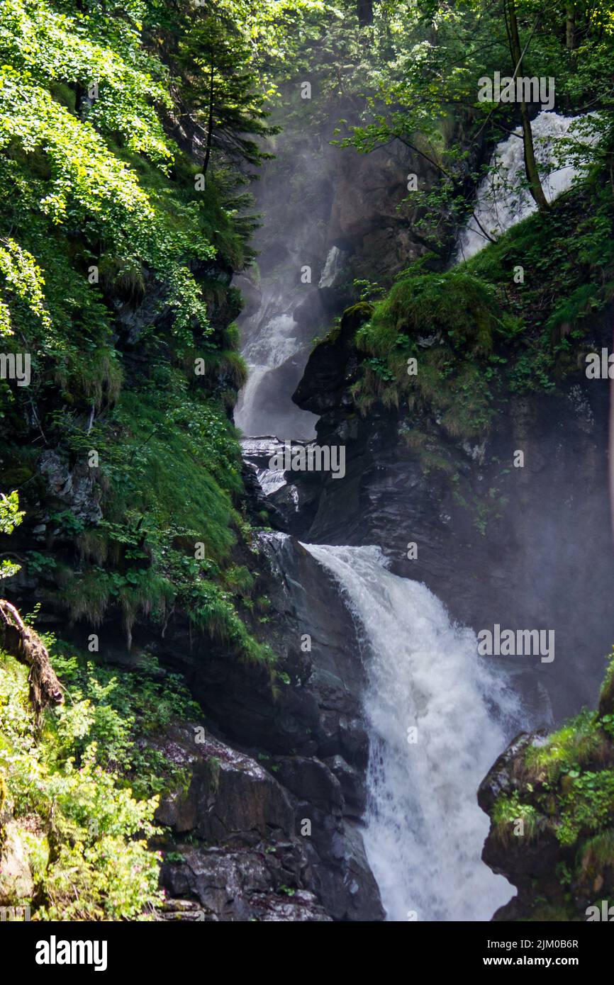 The vertical shot of a mountain forest waterfall Stock Photo - Alamy