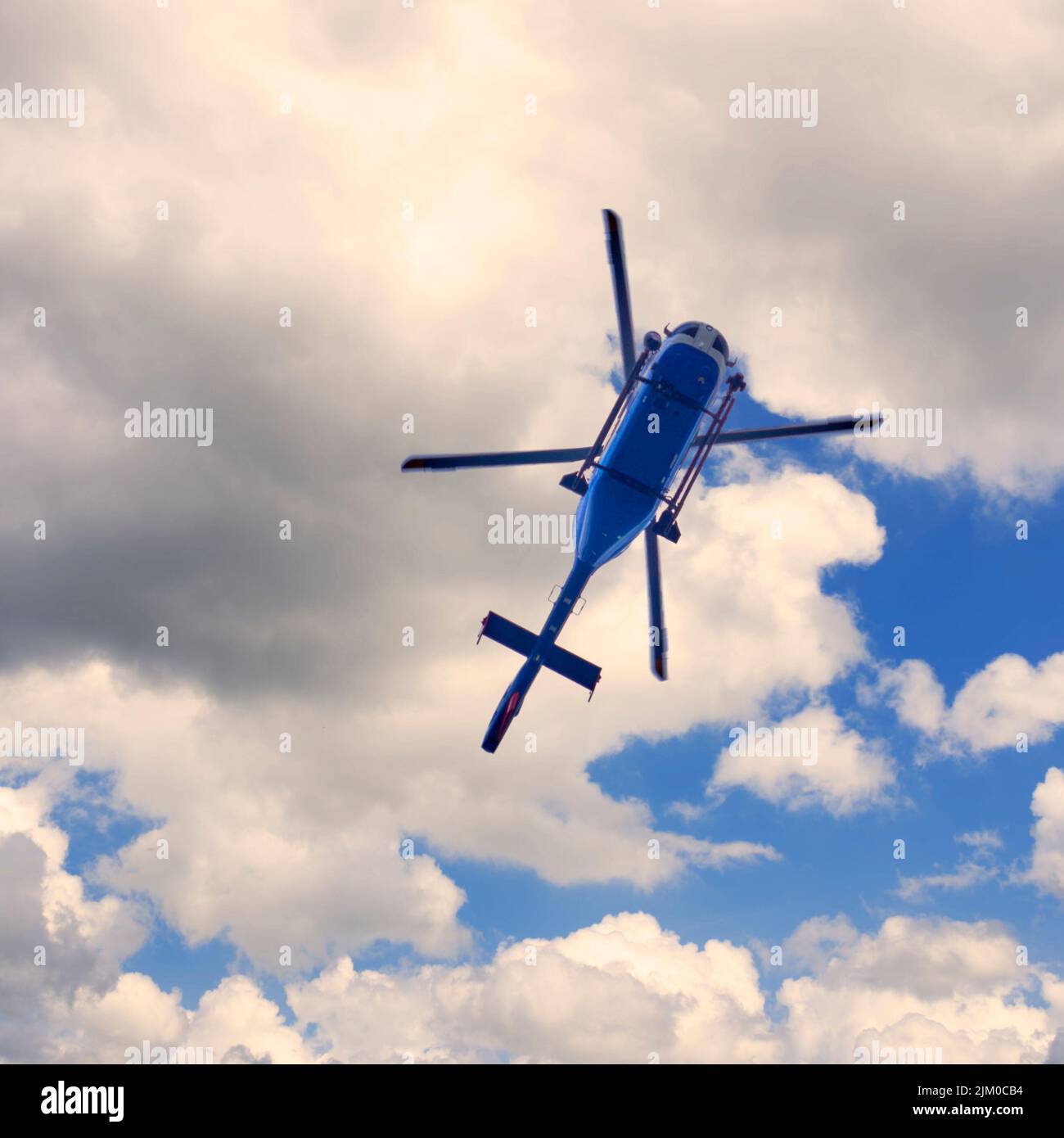A directly below shot of a helicopter flying in the sky Stock Photo