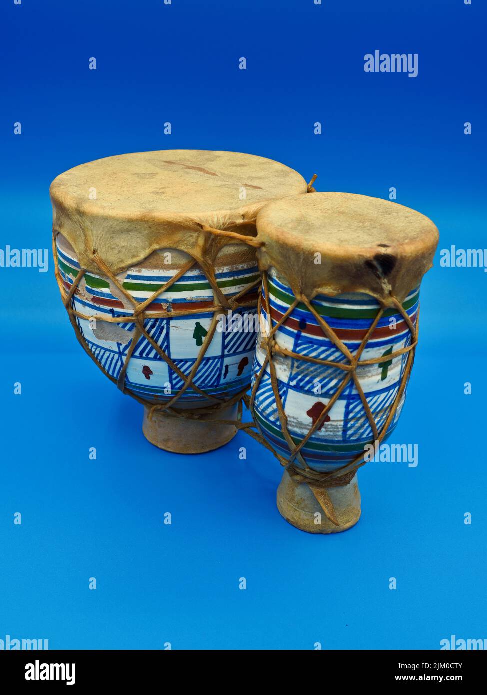 isolated view of an african bongo drums on a neutral blue background Stock Photo