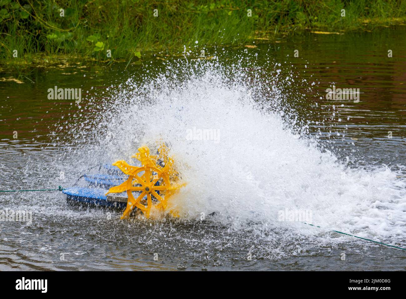 Rotary aerators used in large fish ponds Stock Photo Alamy