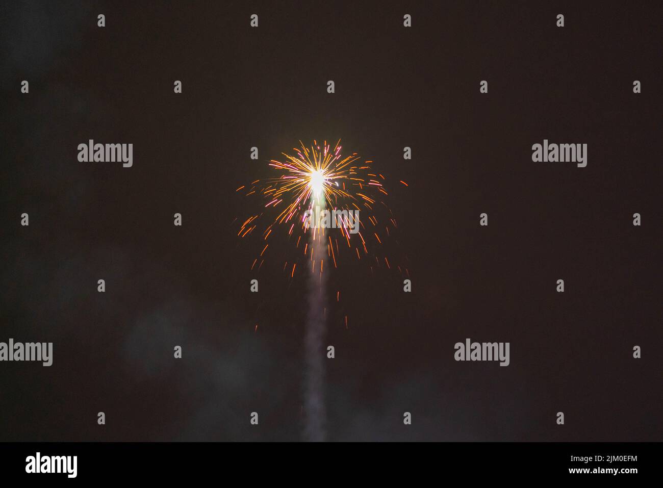 A closeup shot of a firework rocket shooting up and flaring during the ...