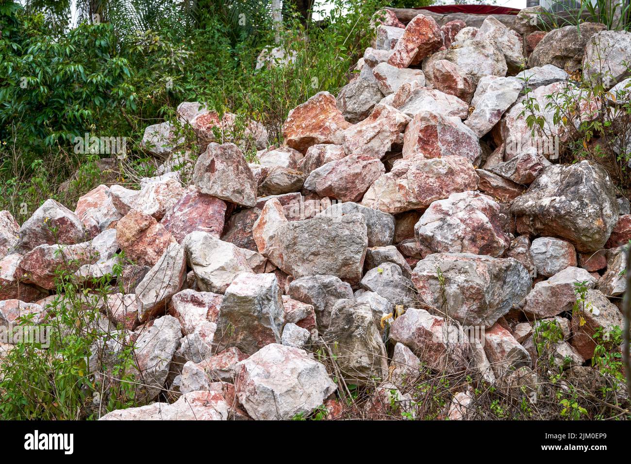 large-piles-of-rubble-produced-by-blasting-mountains-in-the-wild-stock